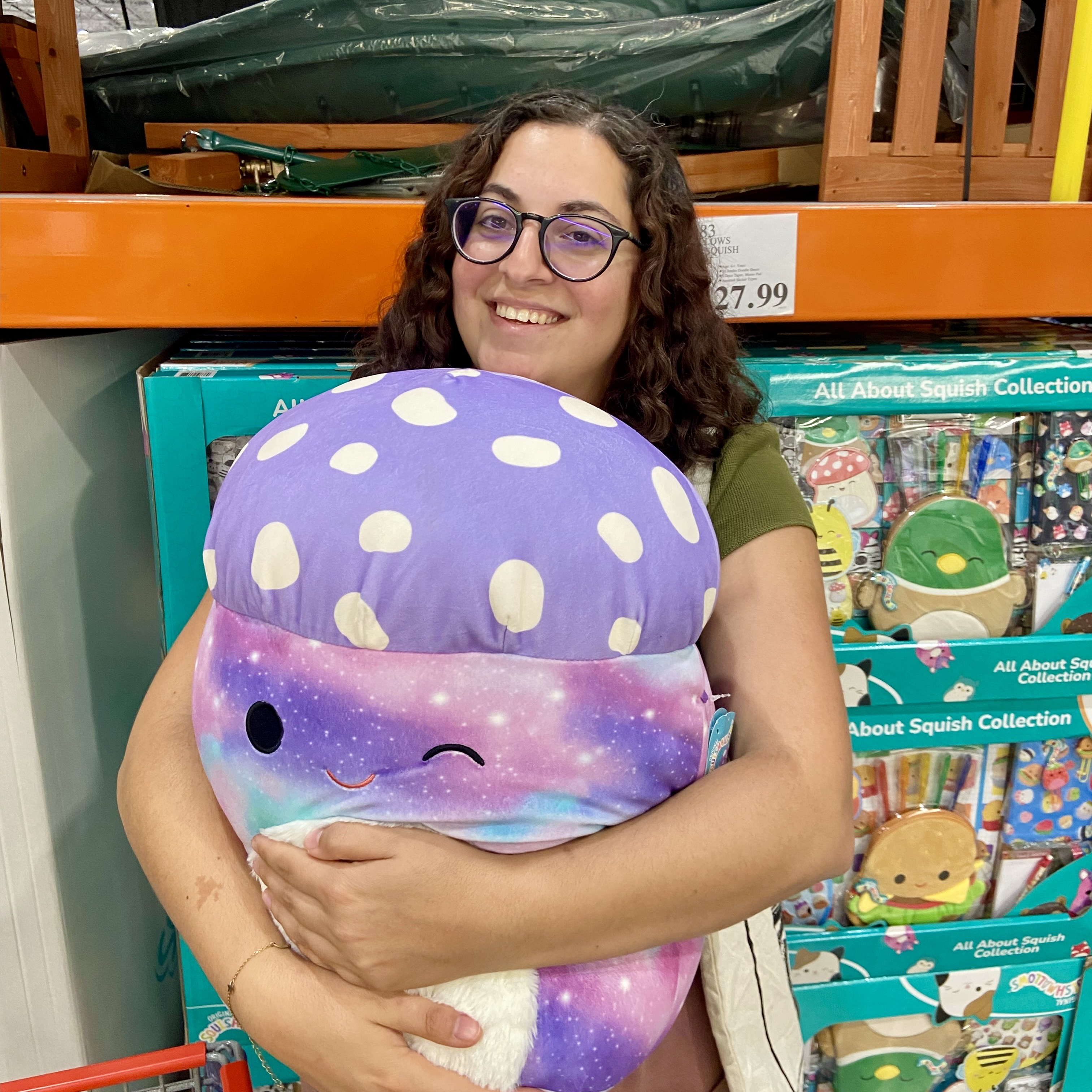 a headshot of odelia holding a squishmallow mushroom